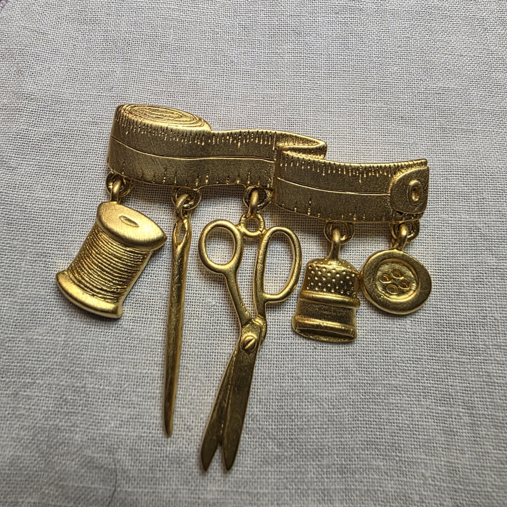 Vintage JJ Goldtone Seamtress Brooch With Tape Measure And 5 Charms